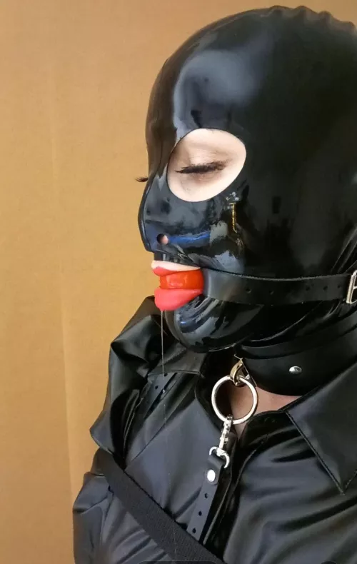 Hooded girl with a ball gag