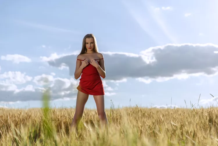 in a red dress on a rye field