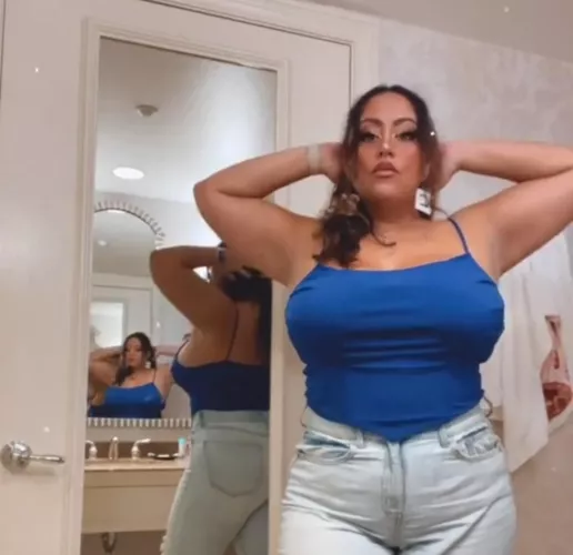 Pulling her shirt tight