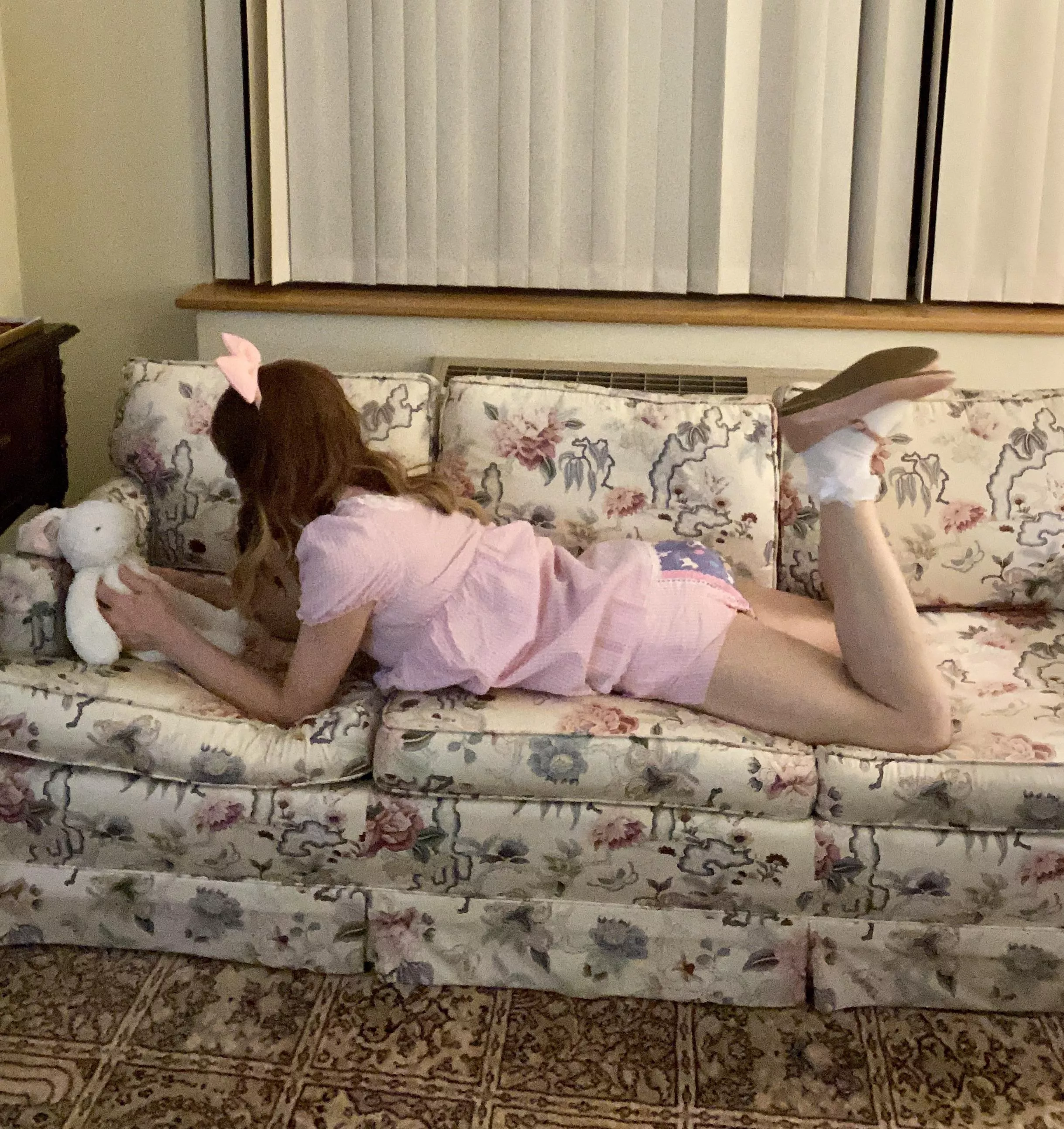 My little on the couch talking to Flopsy the bunny. Baby G has a new “hairstyle.” (Not our house tho.)