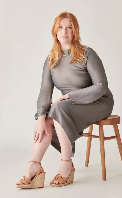 Curvy red head in grey dress & wedge heel sandals