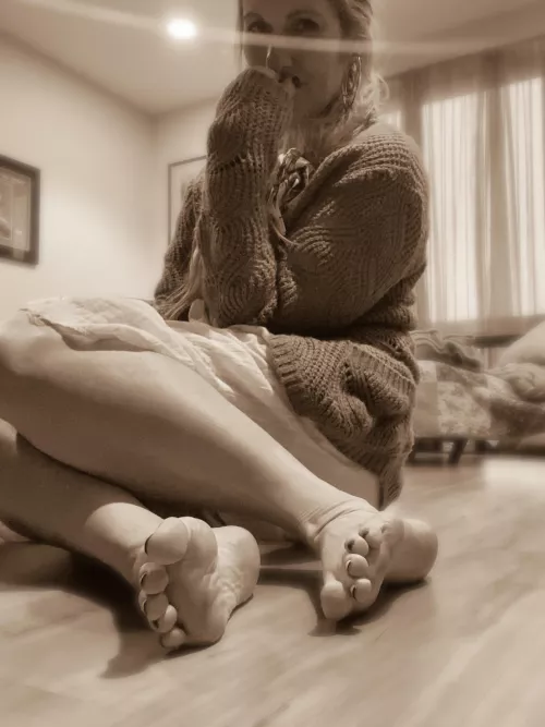 She sits on the floor, covered in dreams.