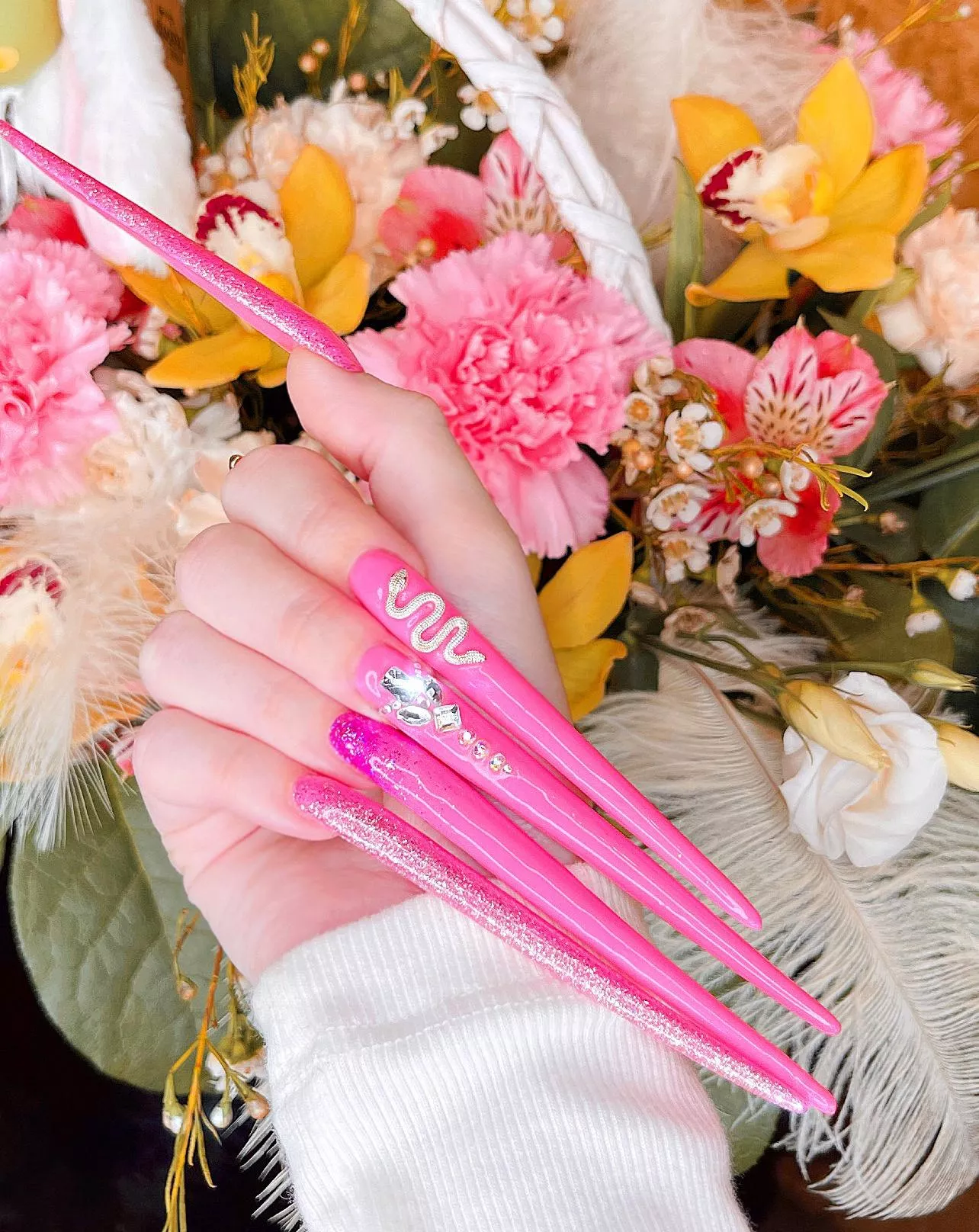 My new long nails with a design of a snake and shiny stones