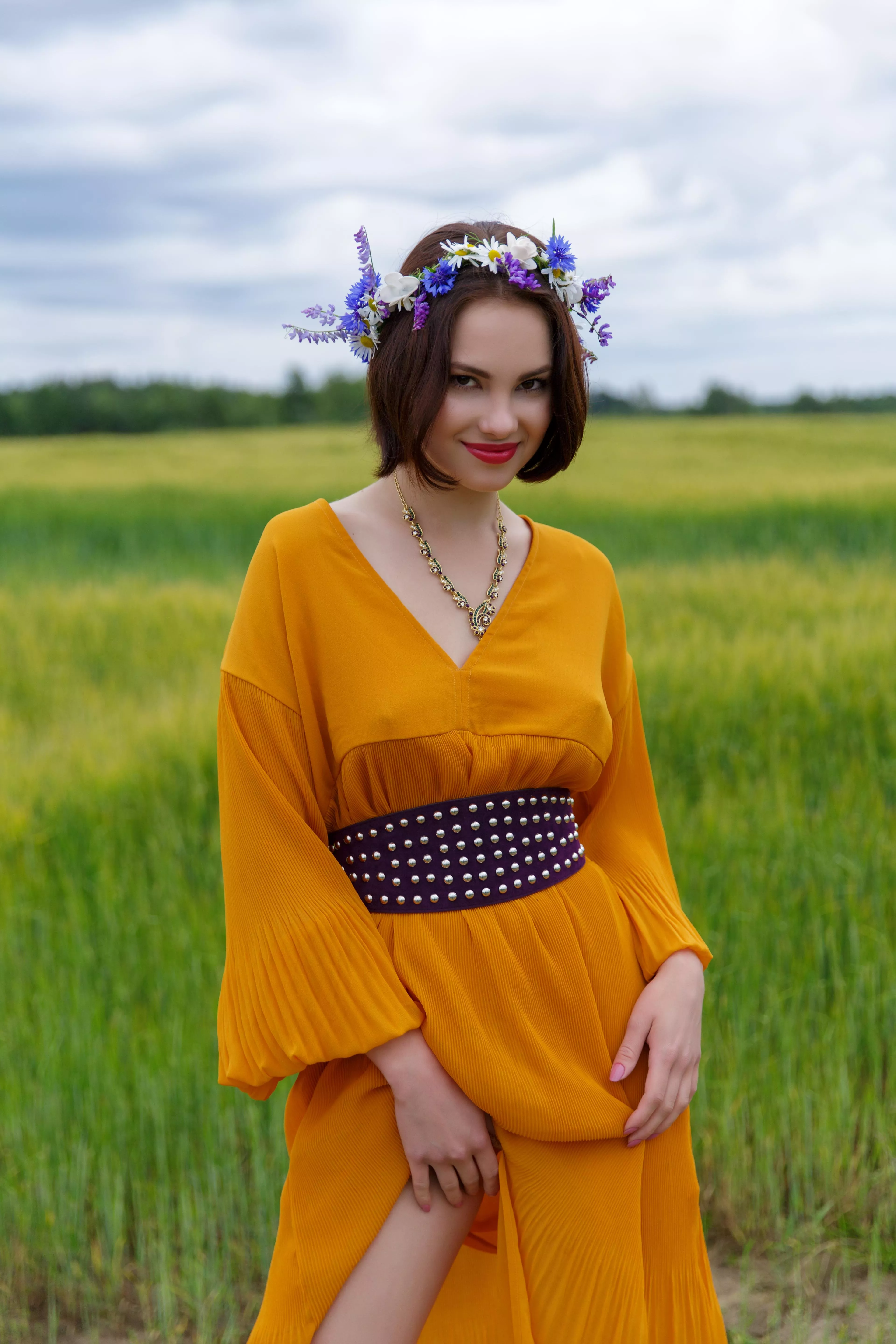 in a dress and a wreath on her head