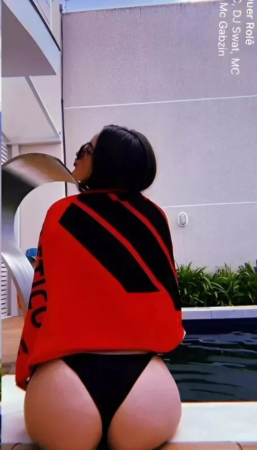 Brazilian in a black bikini.