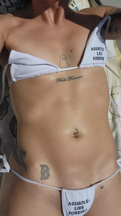 Tiny bikini and skin glistening with sweat