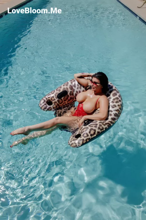 Chilling in the pool with her tits out