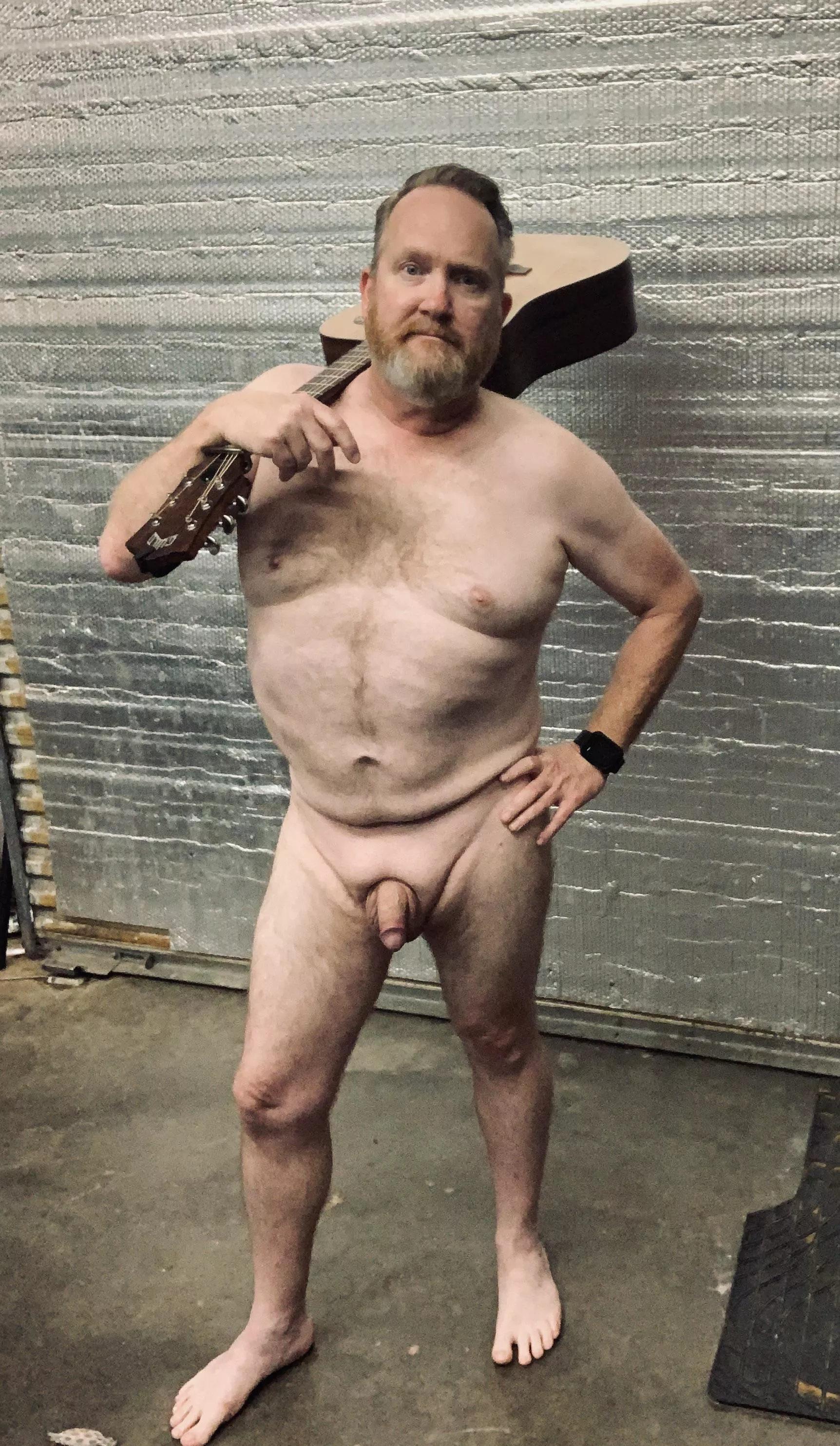 Standing with guitar over shoulder