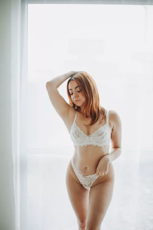 Eden in white lace lingerie.