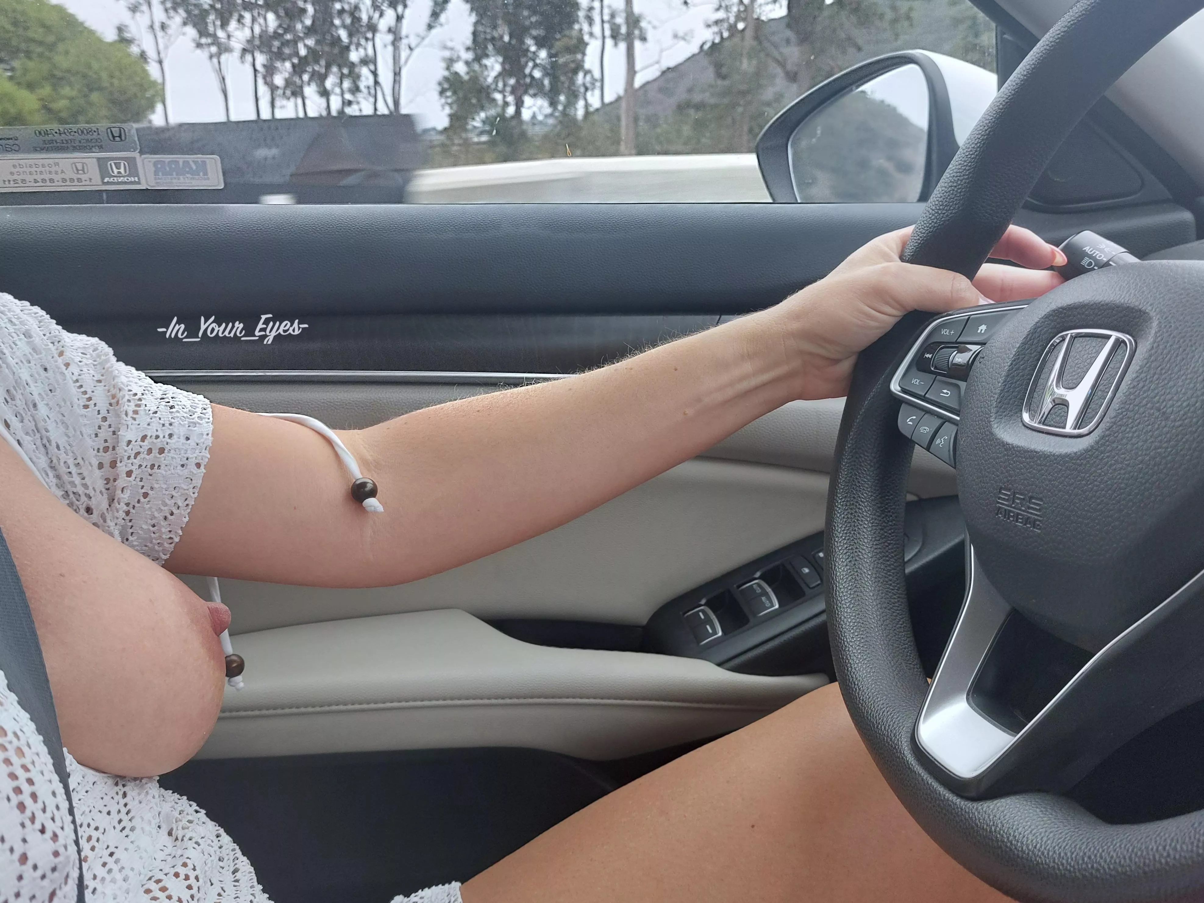 Driving down the road with one tit hanging out