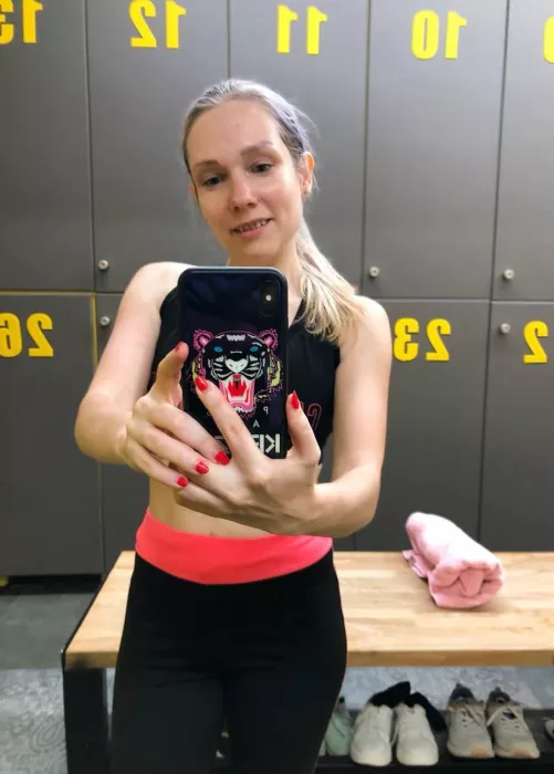 Selfie in a gym changing room: no make up and sweaty after workout