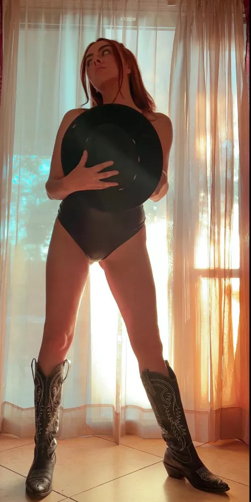Hats off to this sexy redhead in cowgirl boots.