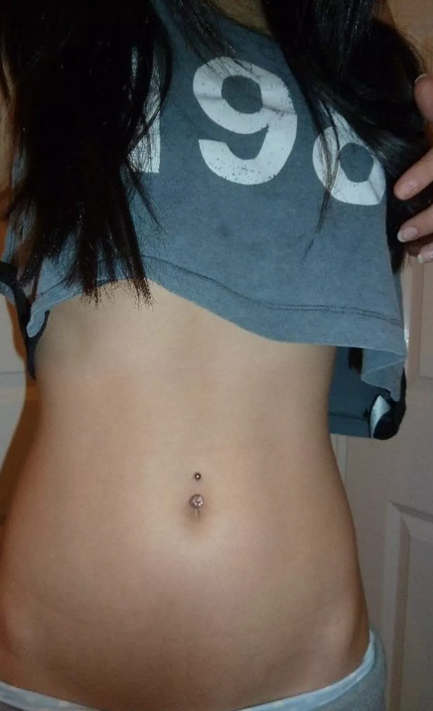 Cute crop top revealing a very sexy midriff and pierced belly button