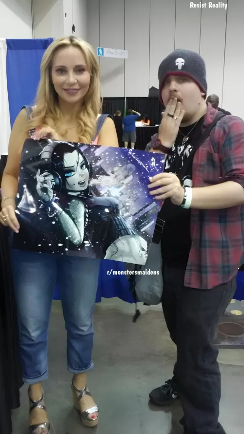 That chick that did the voice for Raven posing with Shadman's Raven. The ultimate boner for Raven fans.