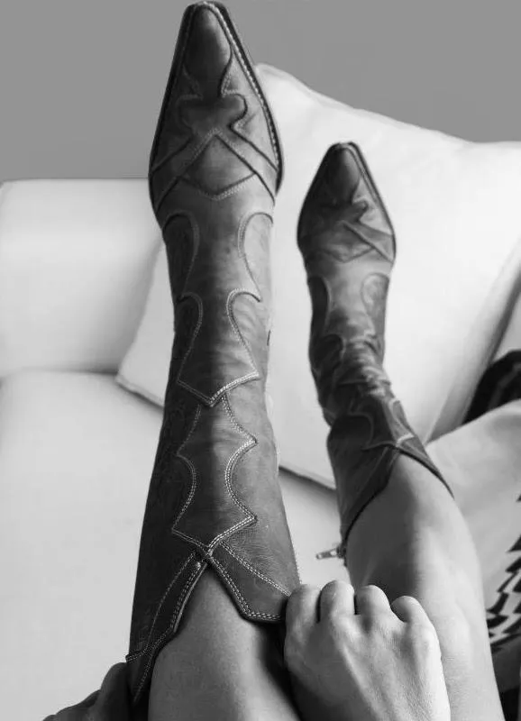 Please help me identify this brand / style of boots for my girlfriend. This photo was from a perfume ad.