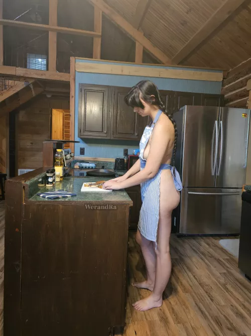 Naturist cooking during cabin vacation