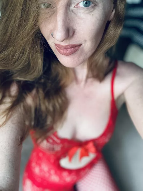 Red fishnet body stocking on a redhead with hazel eyes.