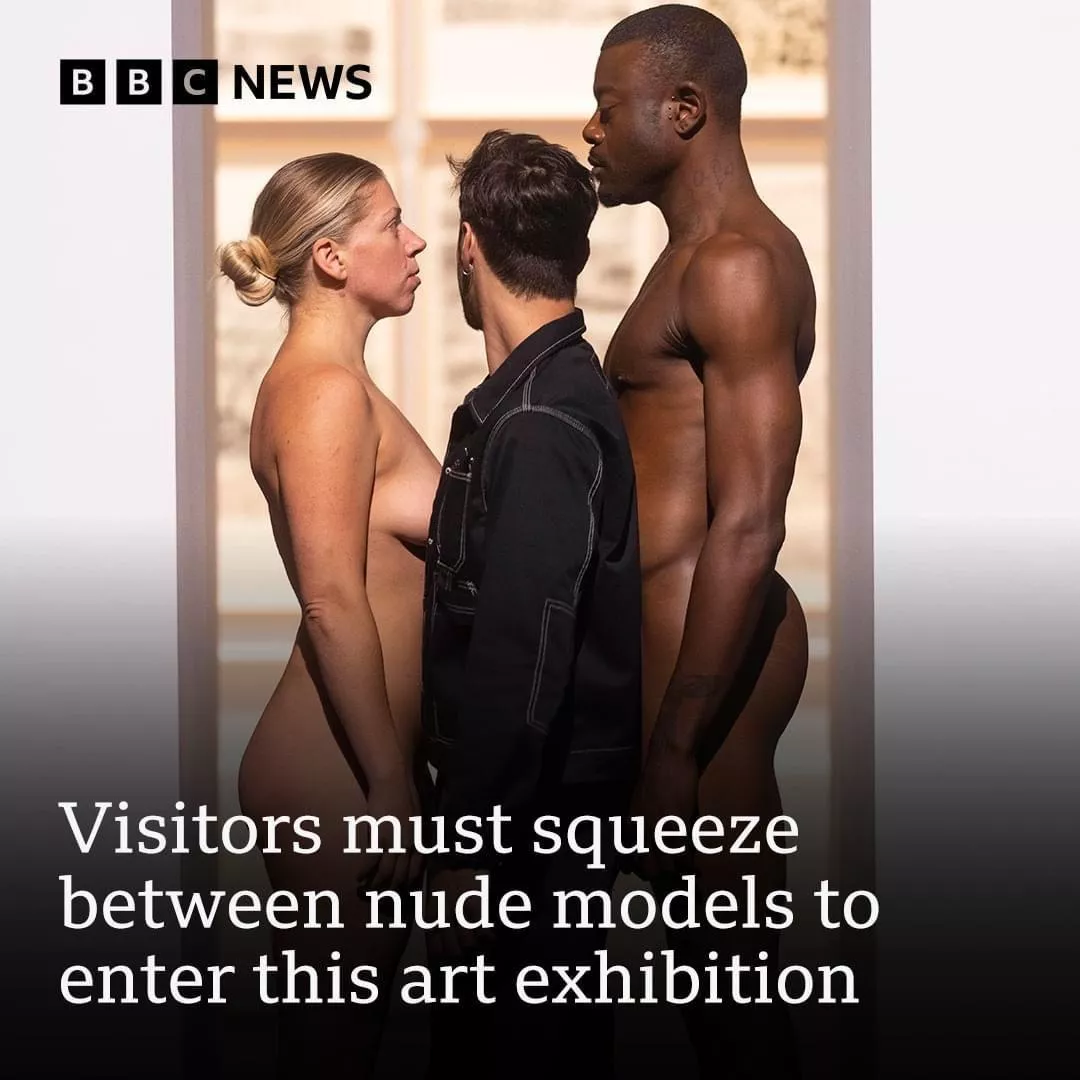 Squeezing through two nude models to enter this art exhibition