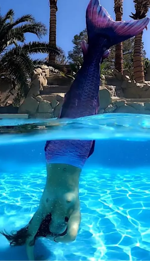 Topless flashing mermaid doing underwater handstands