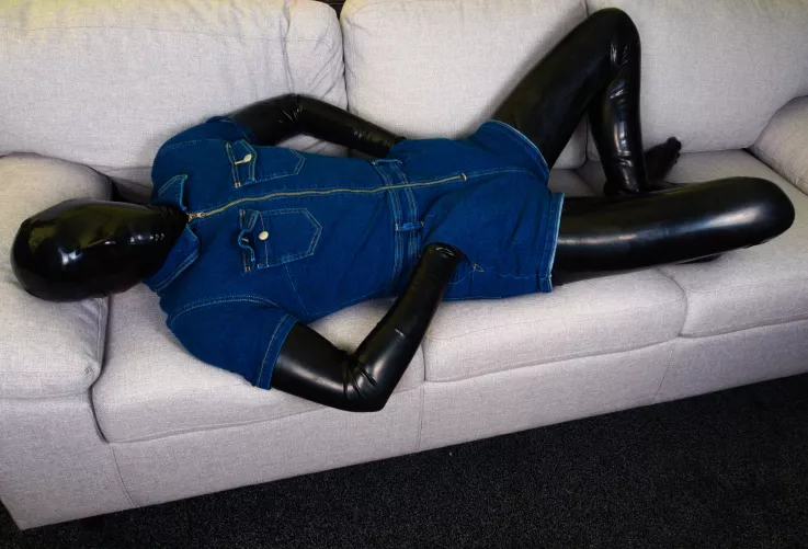 Denim bodysuit over latex catsuit