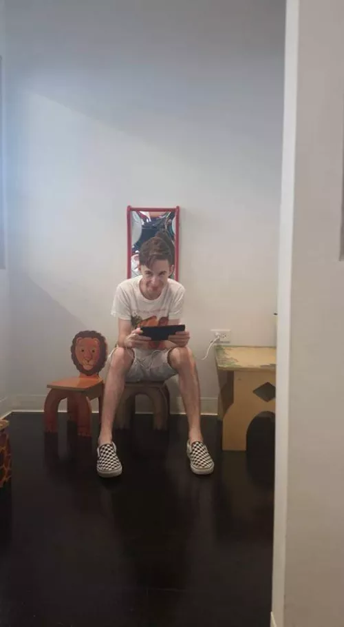 Playing Pokémon Leaf Green on emulator in the kids waiting area of a dealership