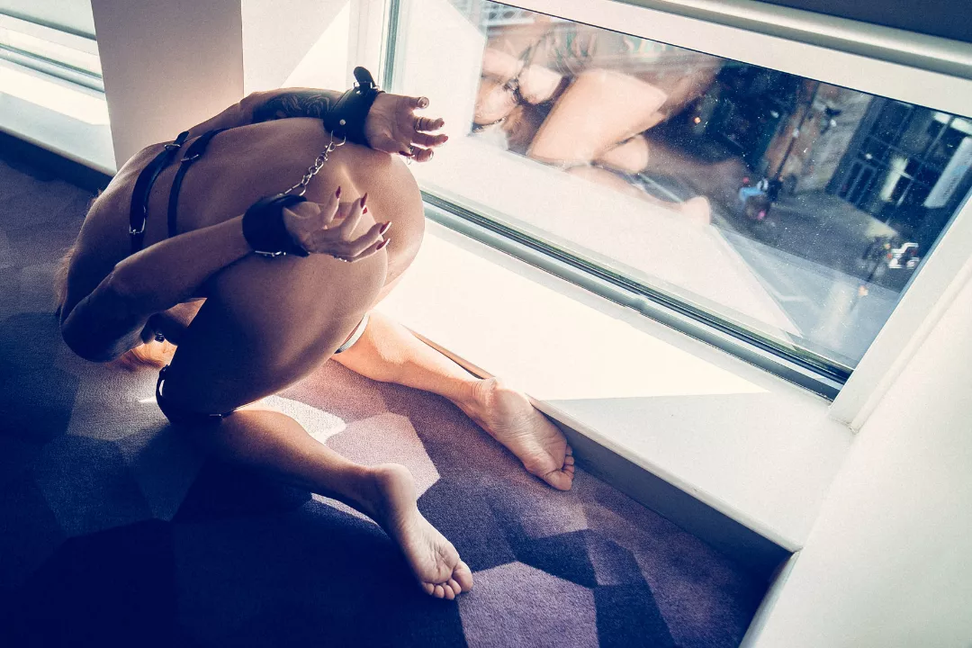 Cuffed by the hotel window for all to see