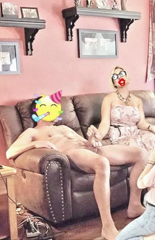 A casual handjob while she poses for a quick pic while chatting at a CFNM gathering.