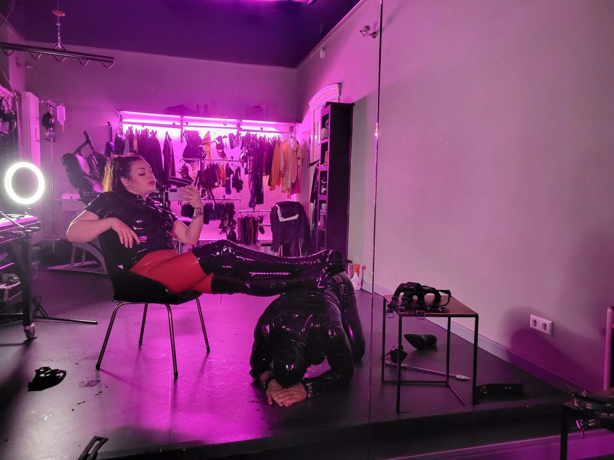 Human footrest for his latex Mistress