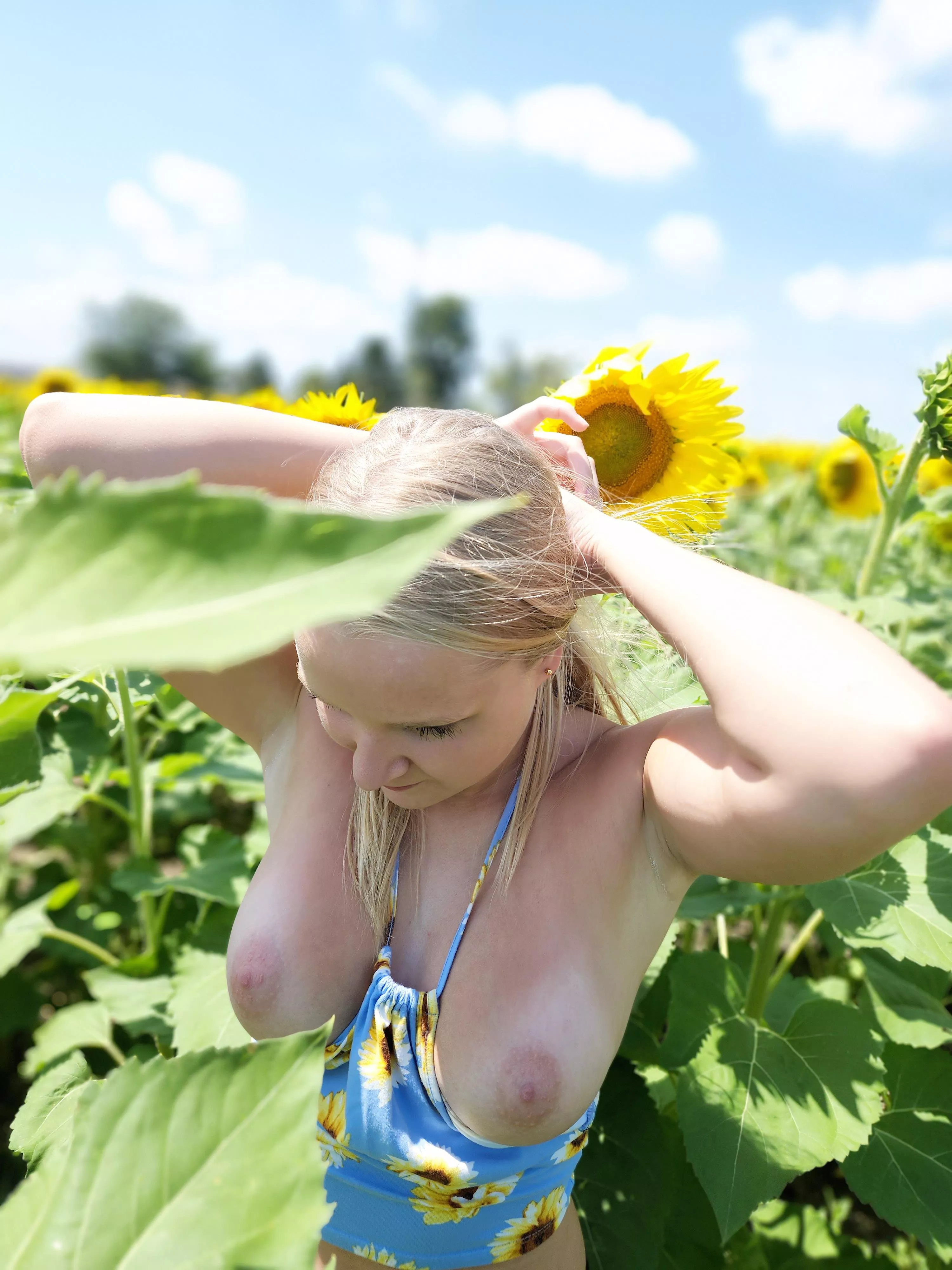 Pulling my hair back for a little fun in the sunflowers