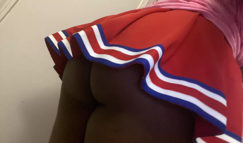 Cute n!gger butt poking out her school girl skirt.