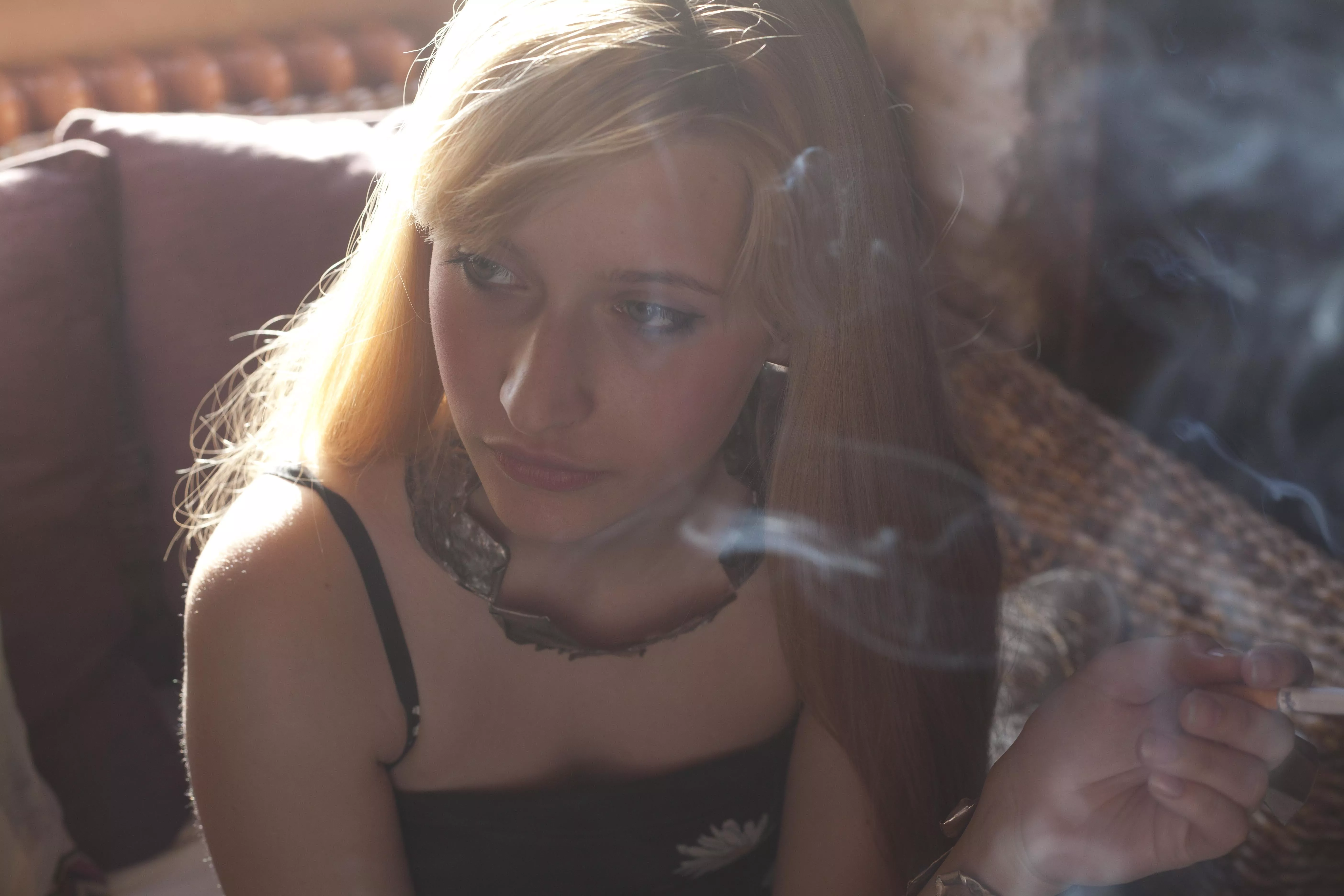 The scent of cigarette smoke on her skin