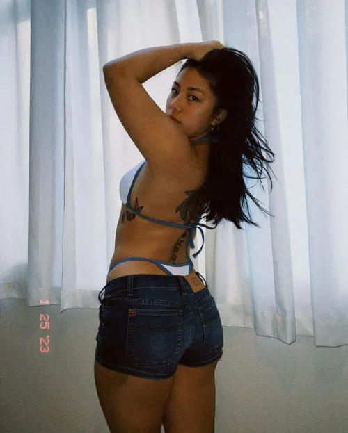 Tatted Asian in bikini and jean shorts