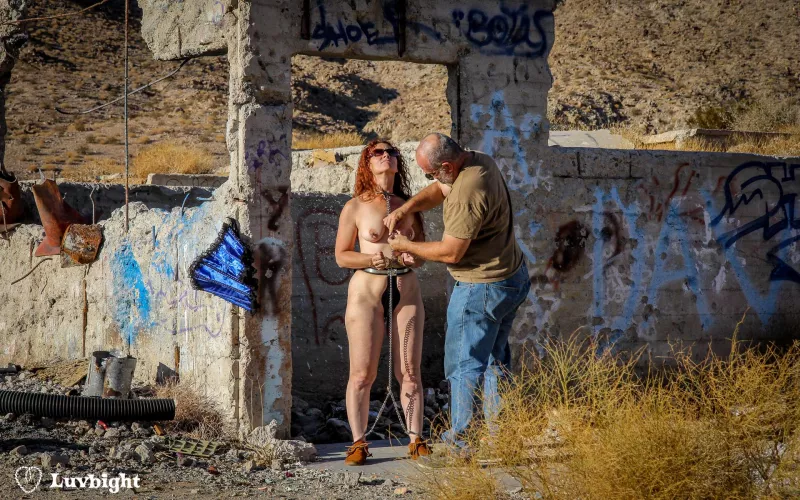 A rare behind the scenes shot of my chaining a belted Dee Luvbight in the California desert for our Apocalypsy series (2011). This is the remains of a hospital building at Berdoo Water Camp.