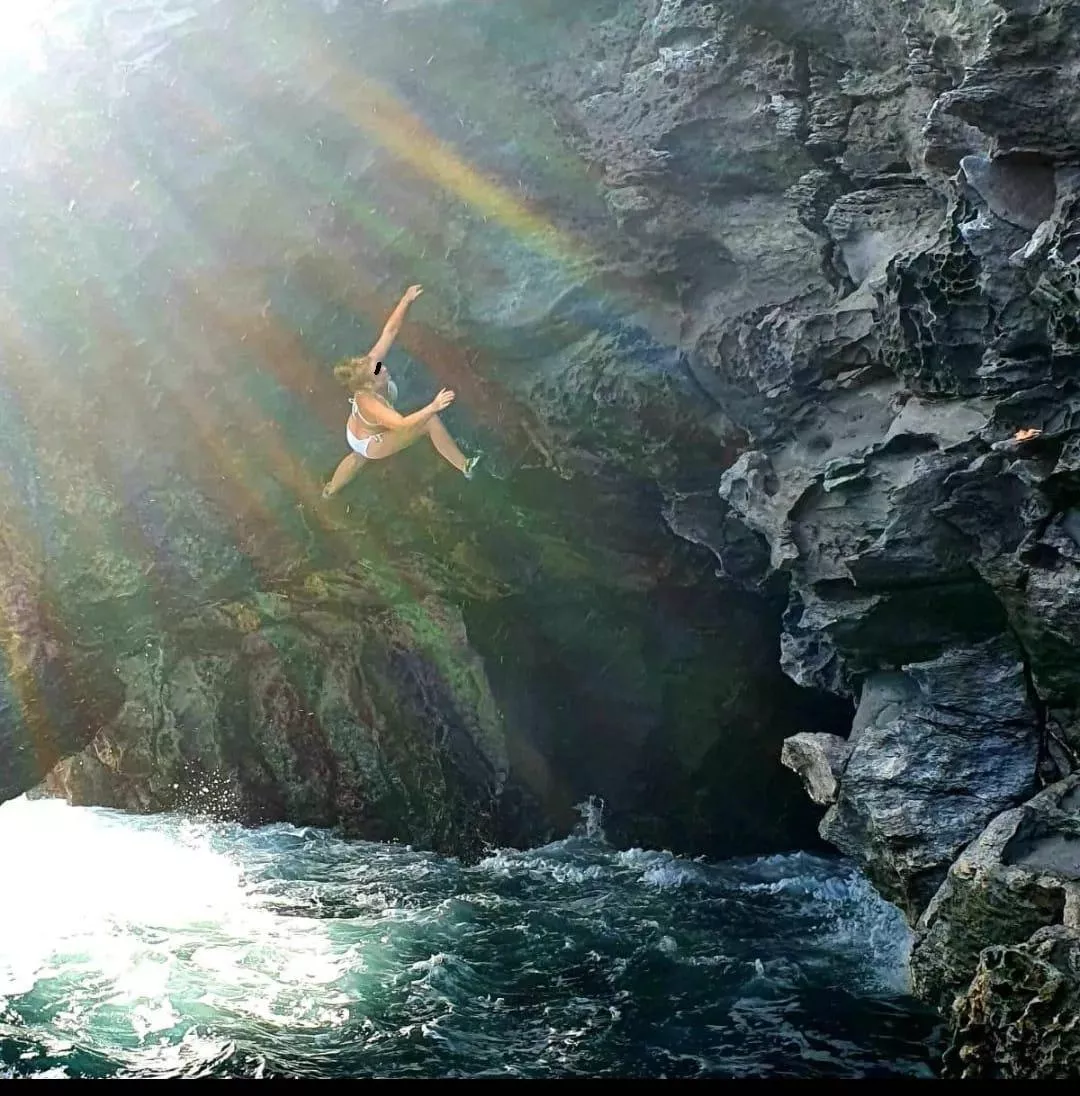 Deep water soloing above a raging sea