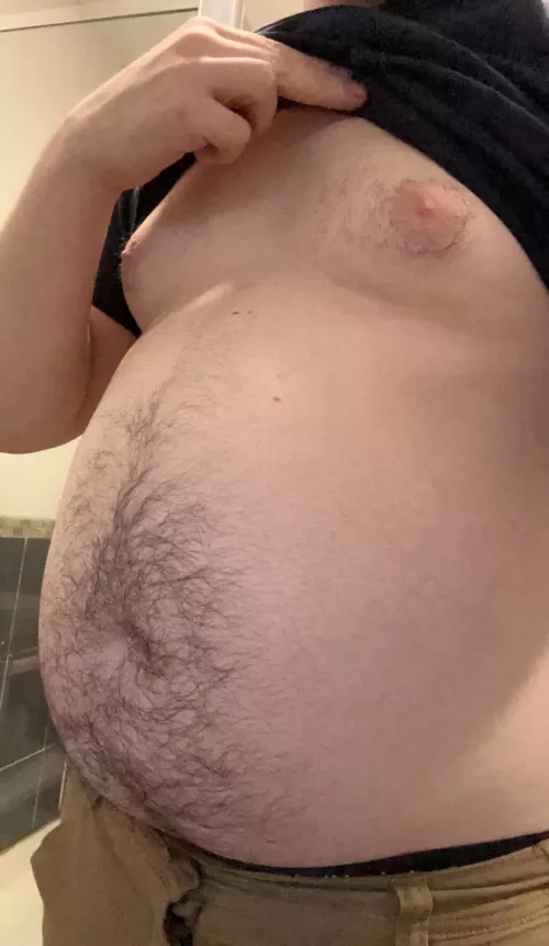 Young guy in sedentary office job put on a gut.