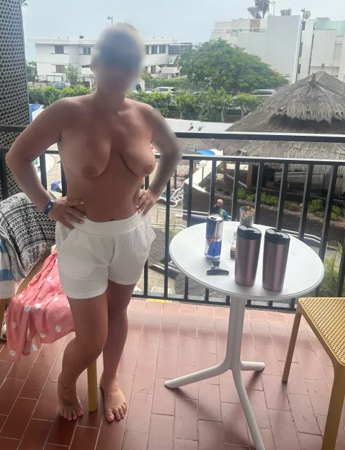 Topless on the balcony for everyone to see