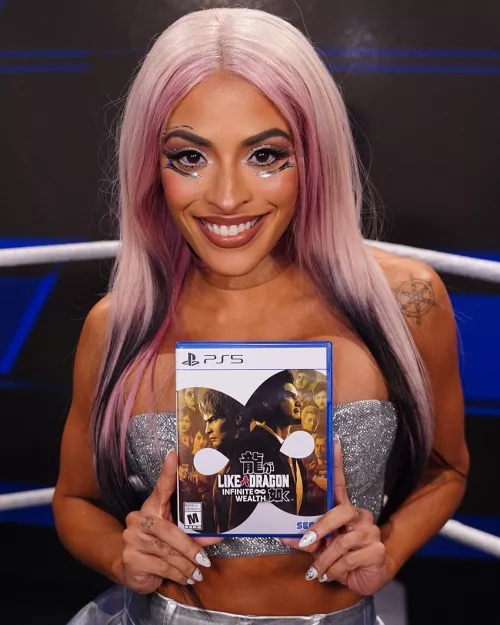 Zelina Vega (holding an all time classic)