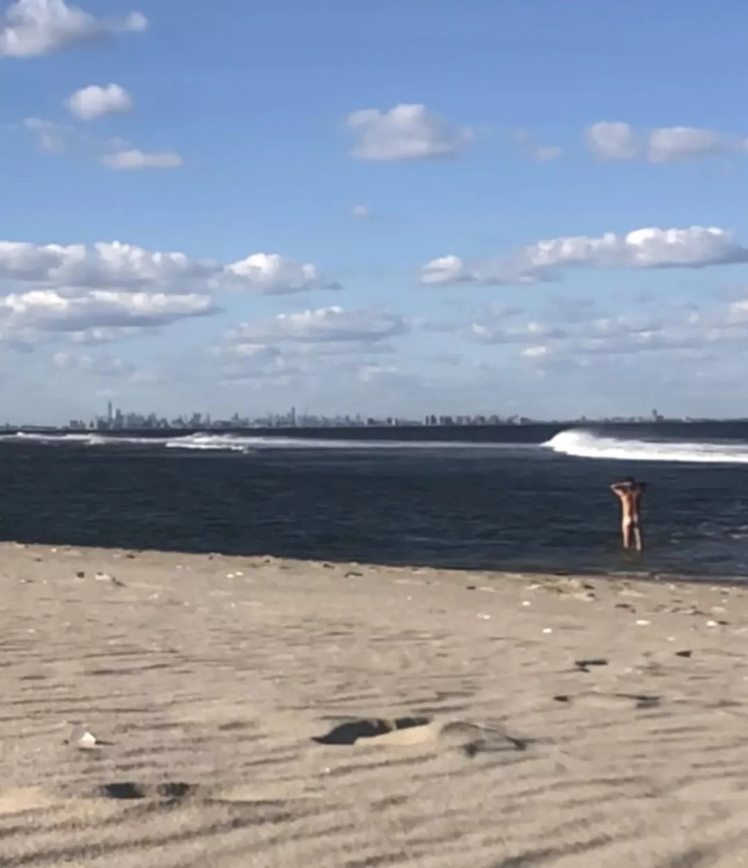 Pausing on a nude beach to savor the moment.