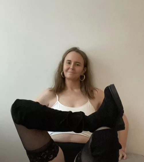 Happy sitting here in my thigh highs and tall boots