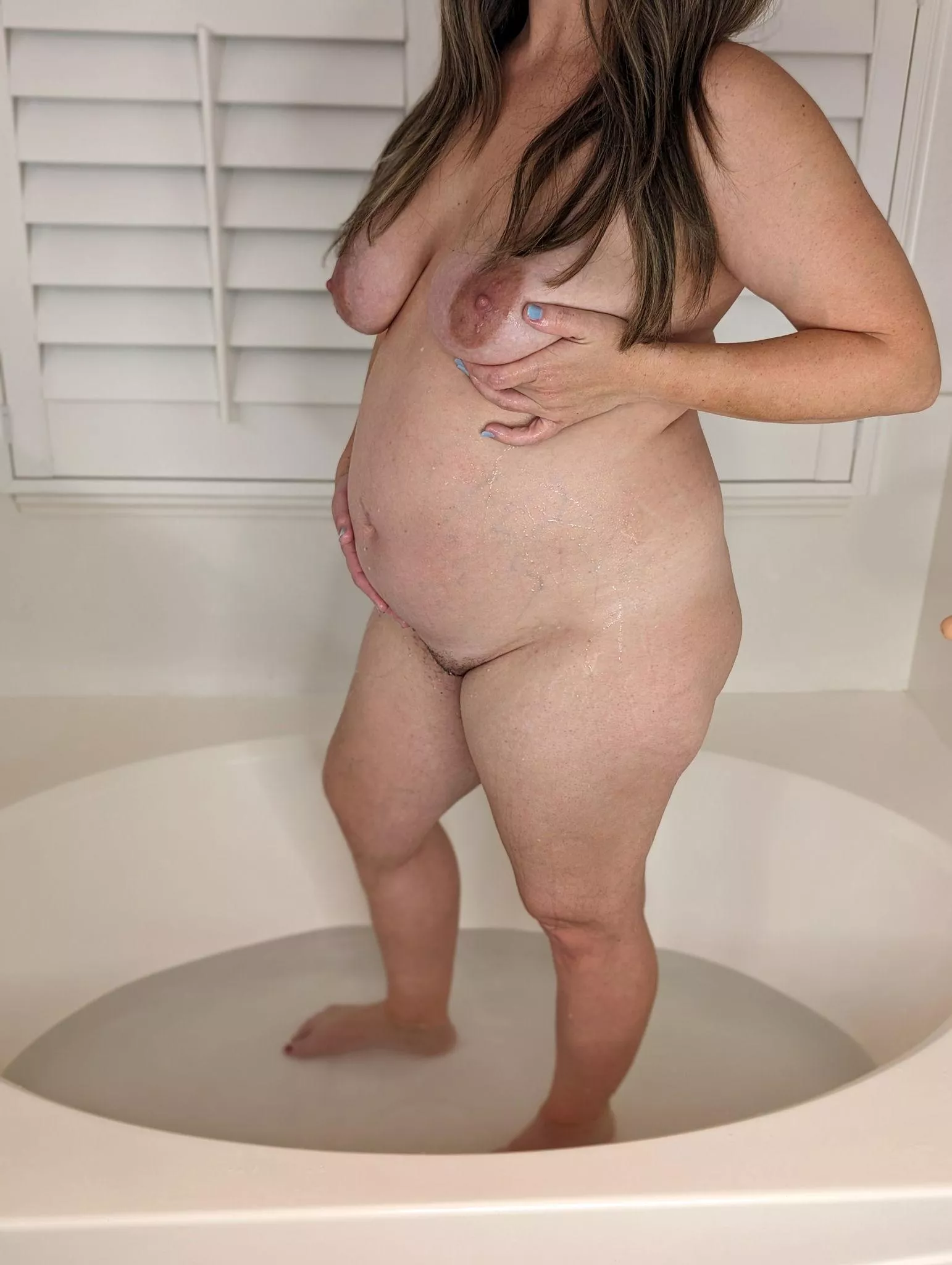 Want to join this pregnant milf for a steamy soak in the tub