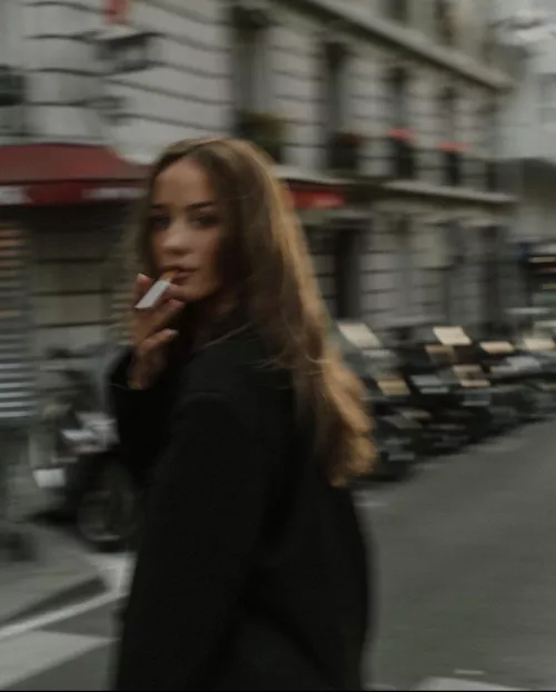 Your eyes meet hers as she passes. You raise your camera…