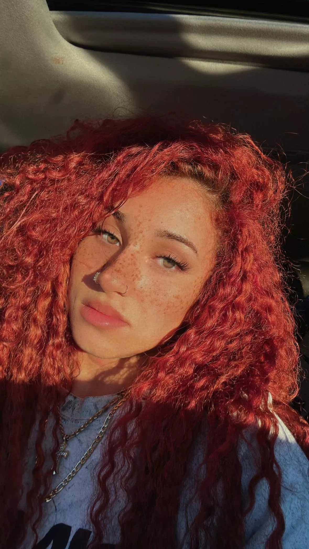 The sunlight's dancing on my freckled face