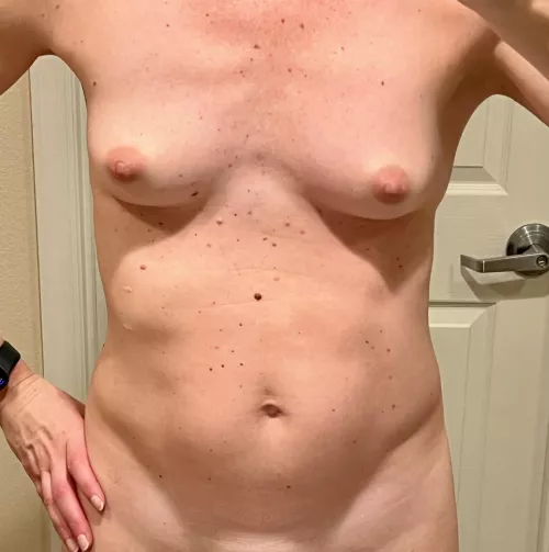 Slightly sunburned tiny MILF tits. No tan lines..