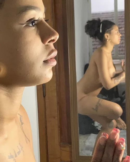 It's strange, the girl behind the glass is doing the same thing as me