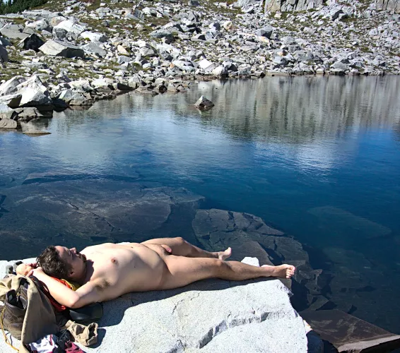 Warming up in the sun before a alpine lake swim
