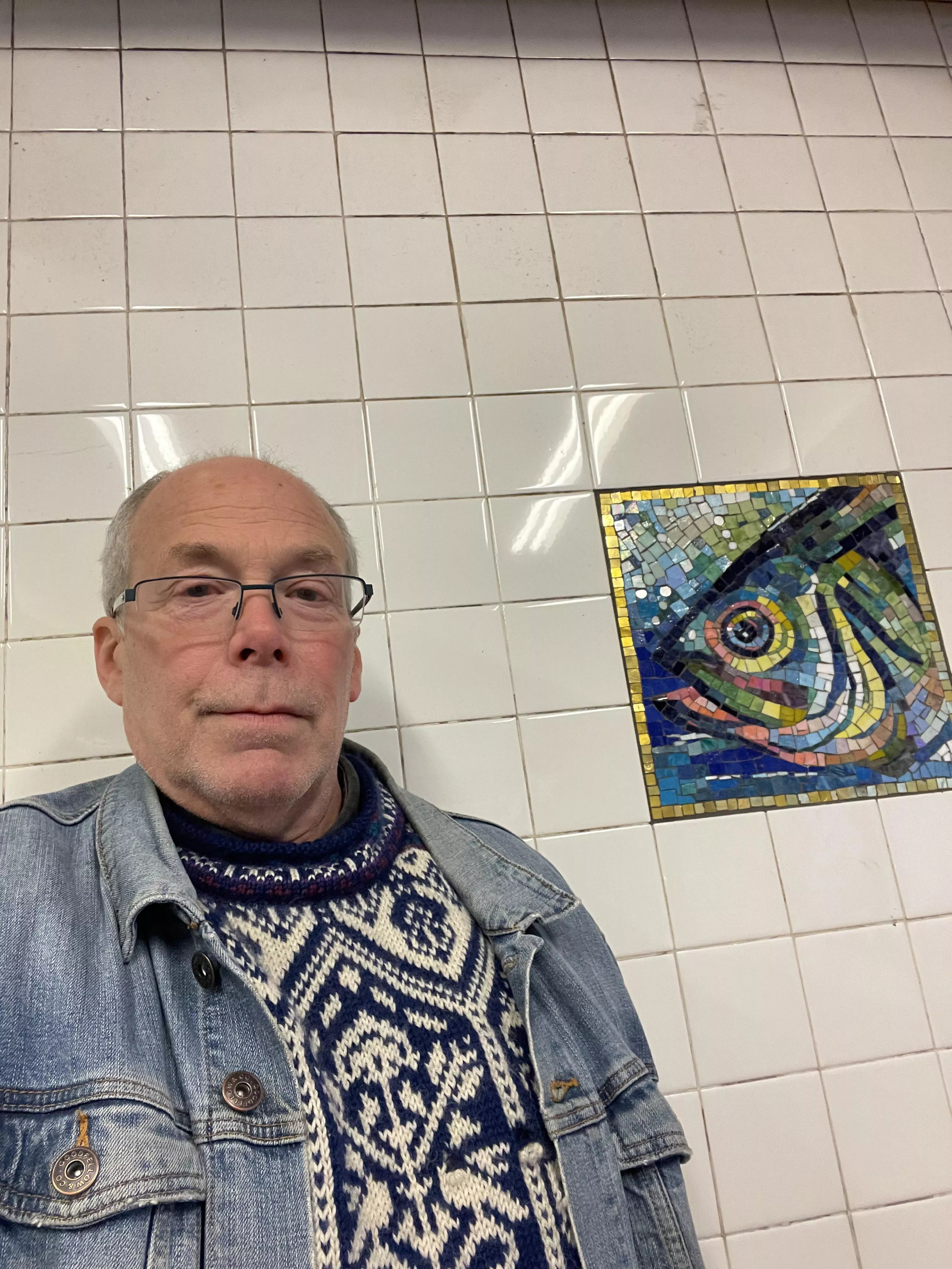 Standing next to a mosaic in the subway. Standing next to a mosaic in the subway.