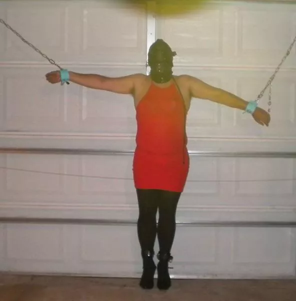 In a dress bound to the garage door