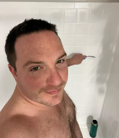 Puppy grout-brushes the shower