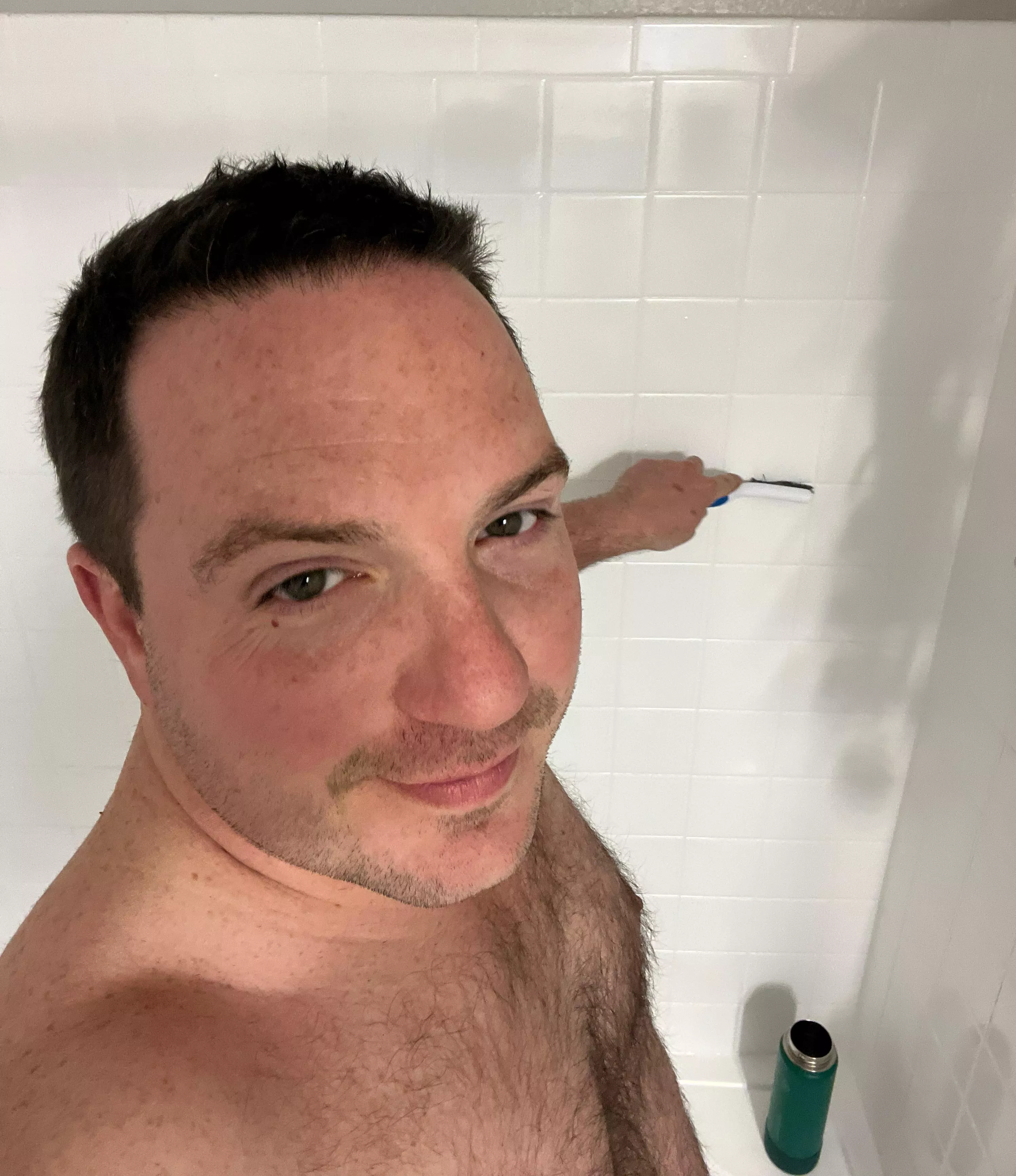 Puppy grout-brushes the shower