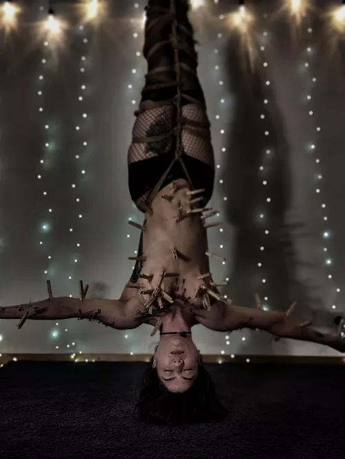 mermaid covered in needles and clothespins